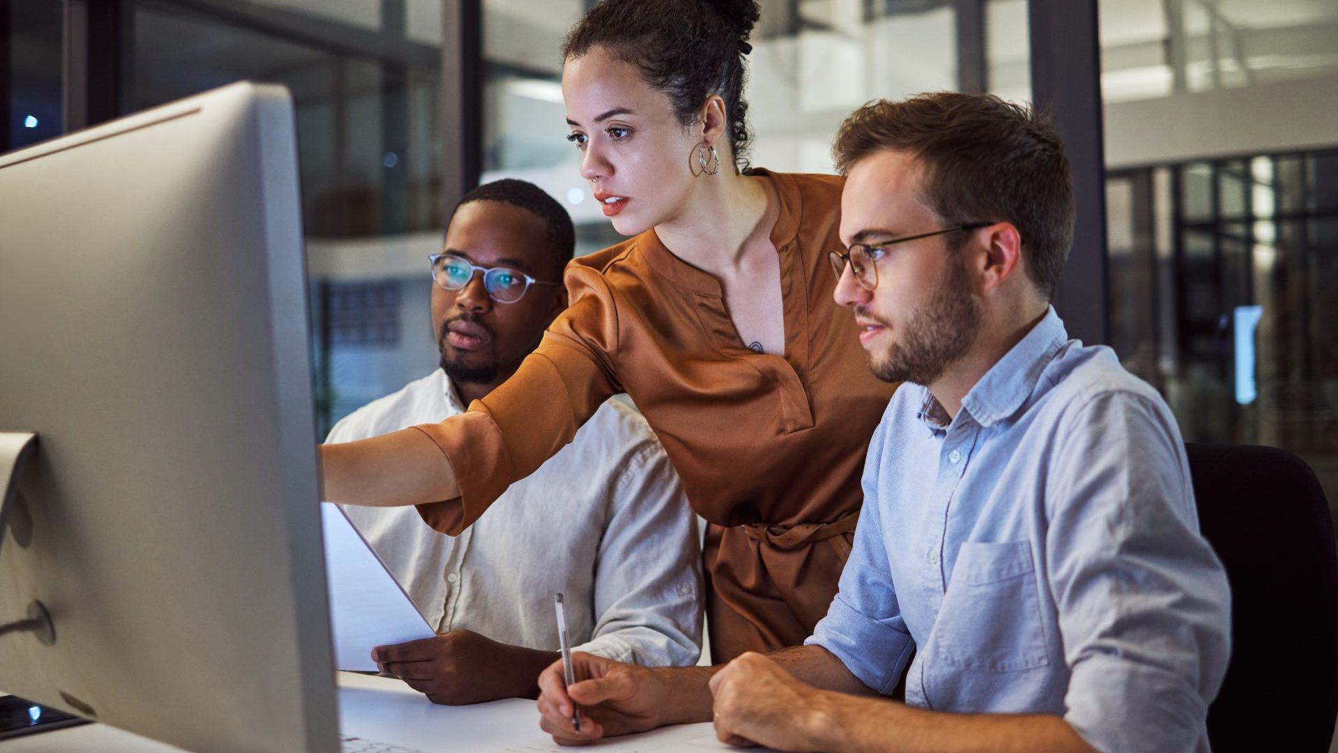 People in a group setting working on things.