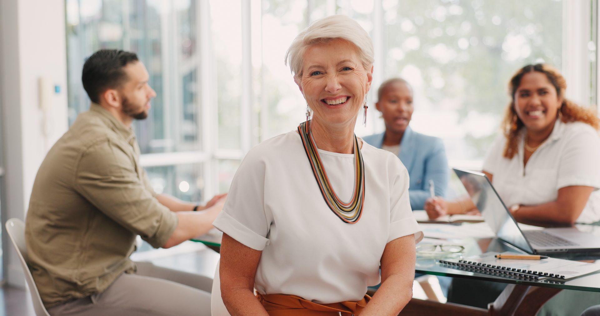 Diverse team meeting and people smiling.
