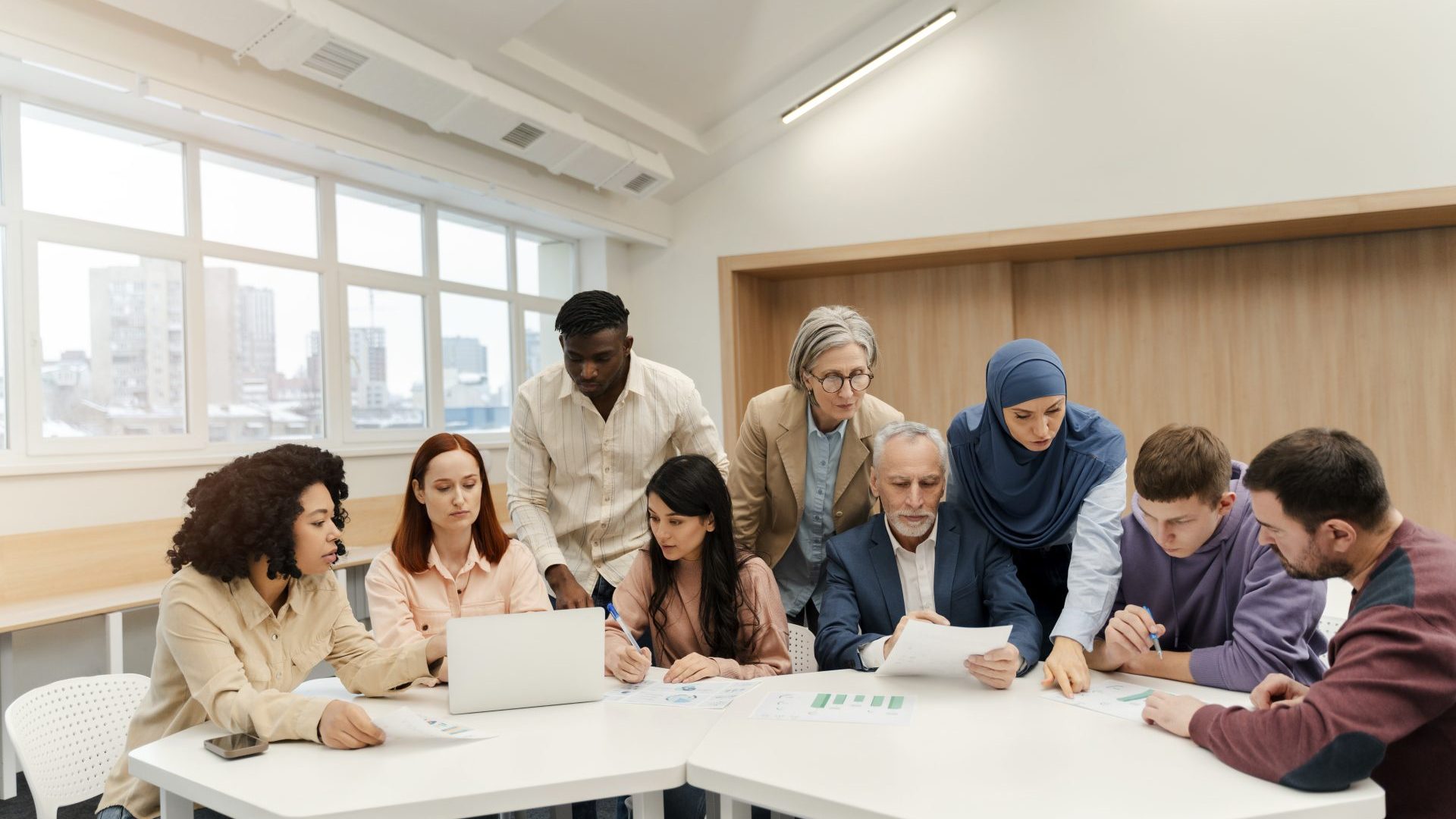 People sitting in a team meeting a circle.