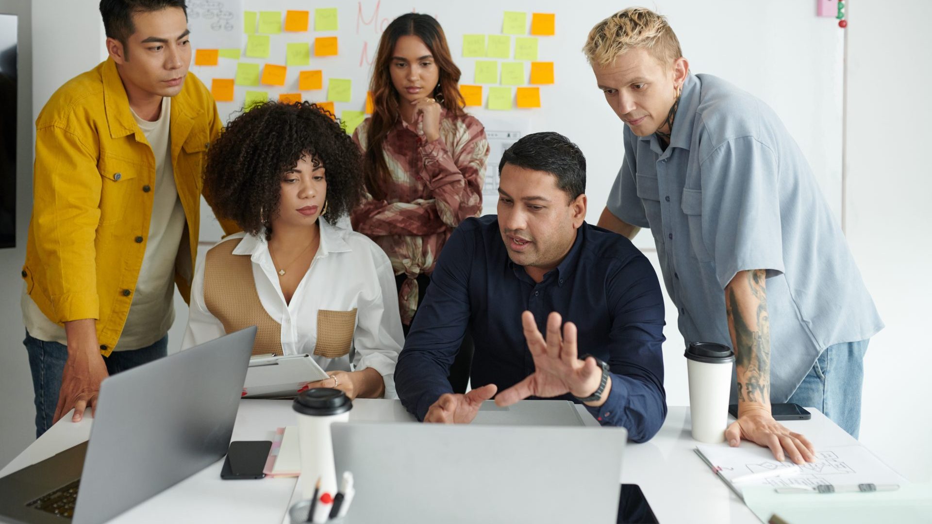 a group of people working in a meeting.