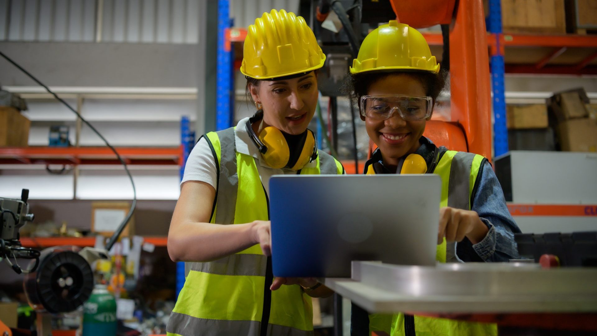 People working front-line looking at a tablet.