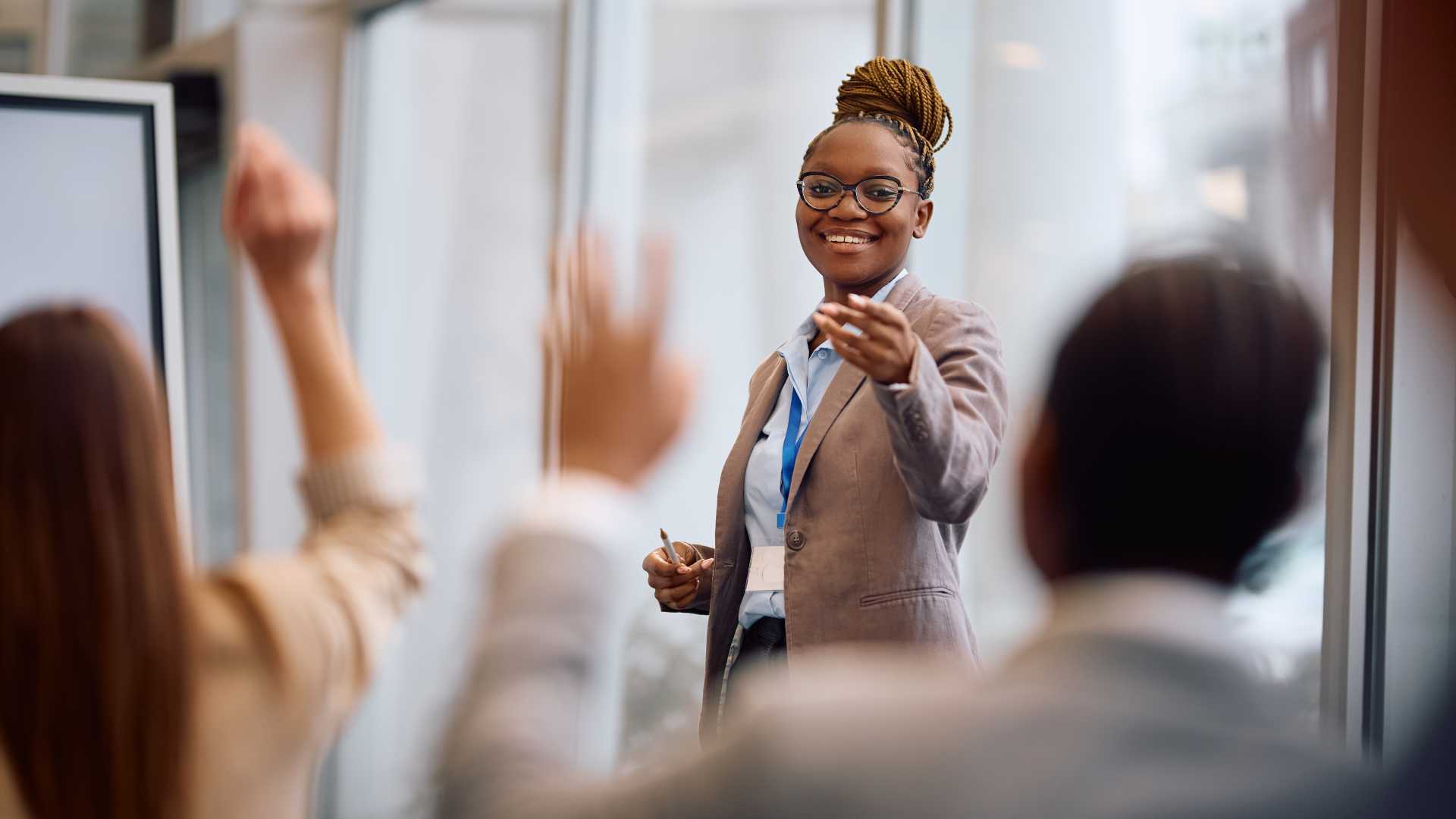 Leader facilitates an interactive discussion with employees, encouraging participation and engagement during a leadership development session on effective communication.