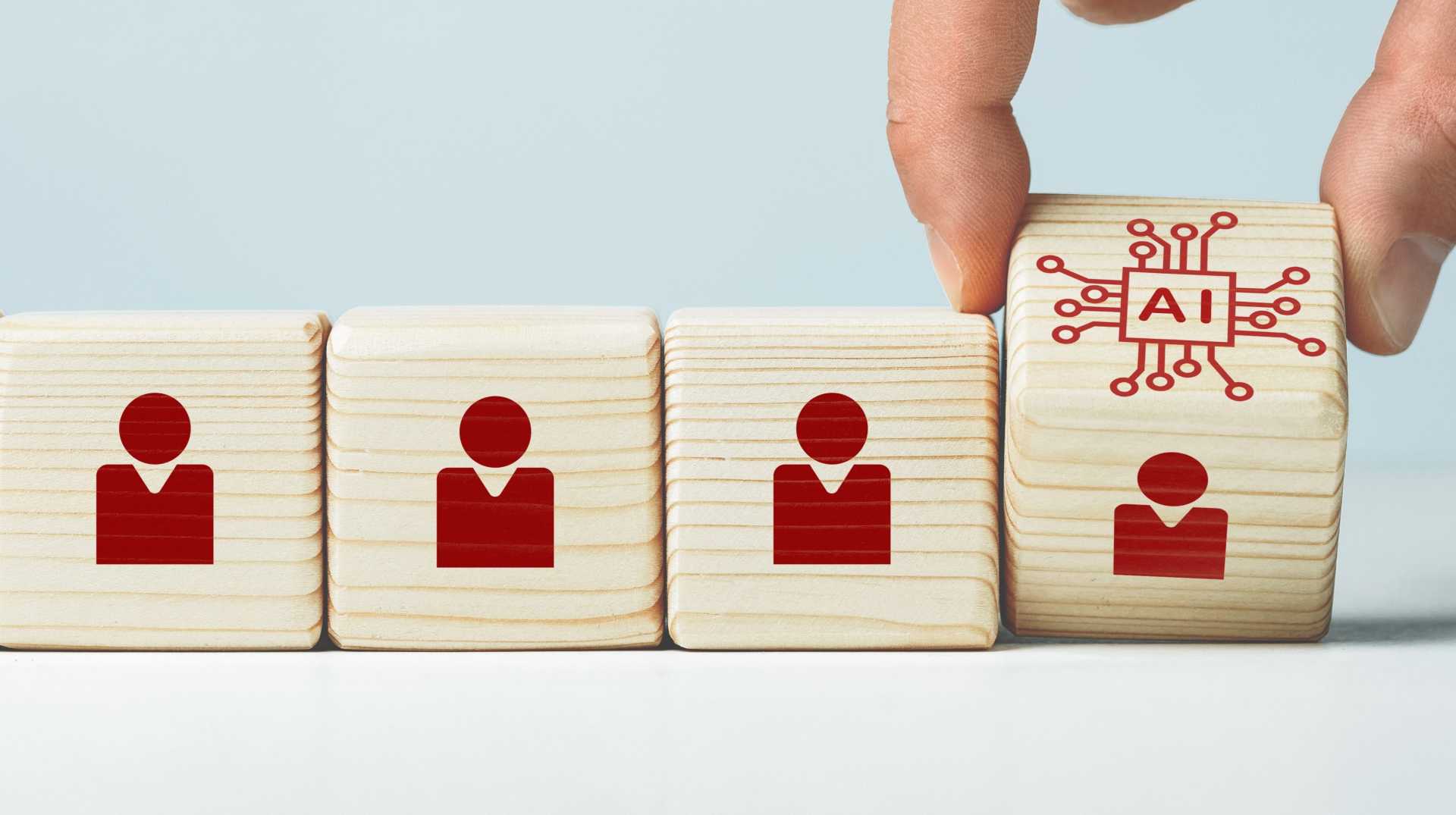 Wooden blocks representing employees and artificial intelligence, illustrating the integration of AI agents into the workforce and human-AI collaboration.
