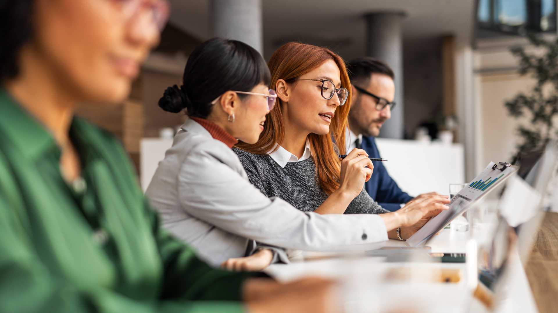 Leaders reviewing information during a team discussion, illustrating structured problem solving, critical thinking and collaborative decision-making in complex workplace situations.