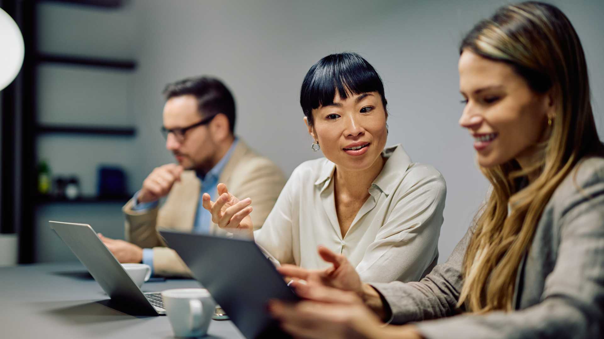 Manager discussing employee skills and development needs with colleagues, illustrating how development conversations can improve skills visibility and identify emerging workforce skill gaps.