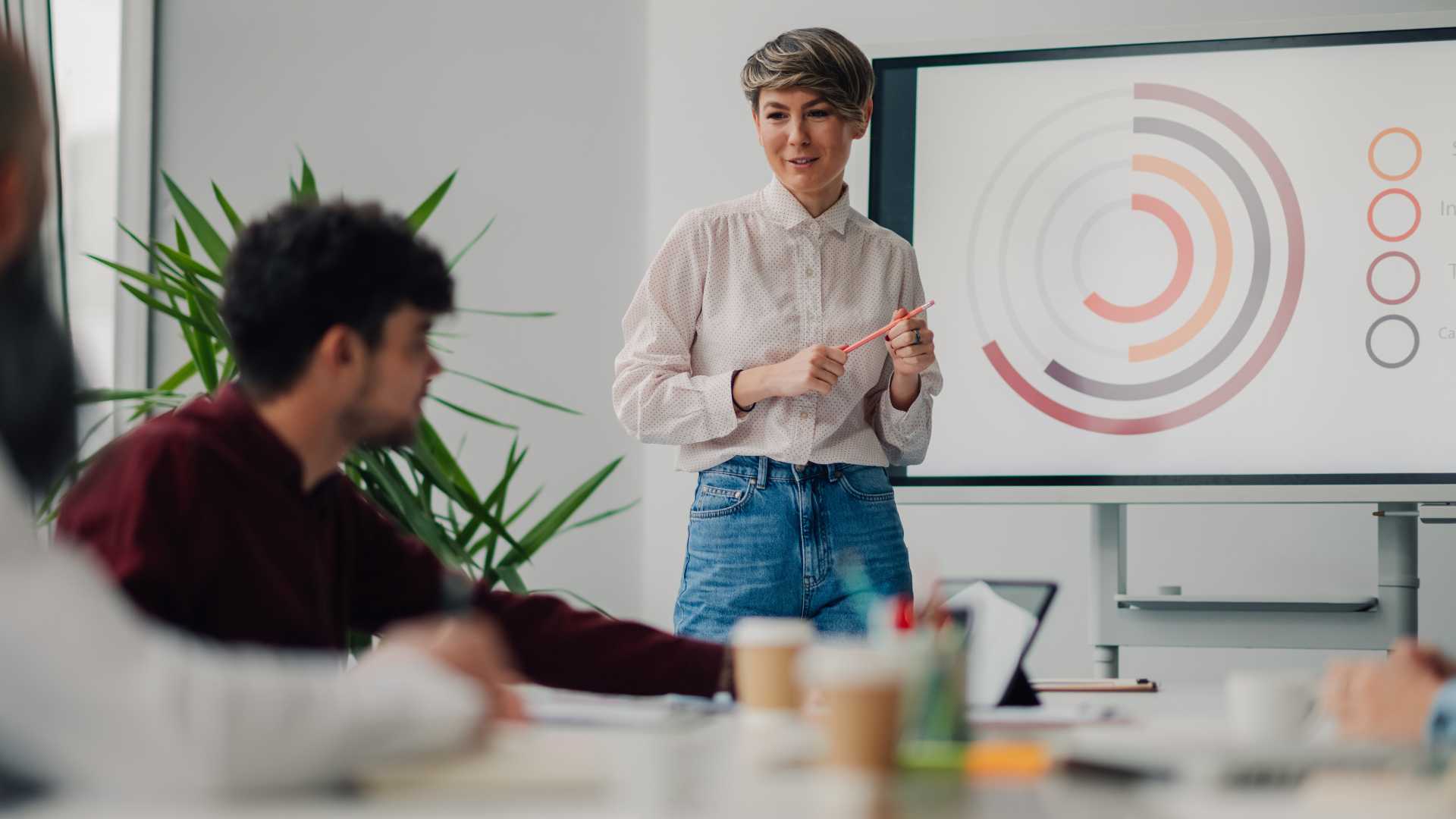 Learning professional presenting workforce data to employees, illustrating skills validation, capability measurement and evidence-based workforce development.